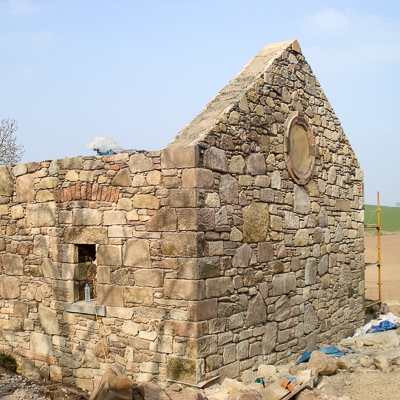Traditional stonemasonry and limework being undertaken on a new build