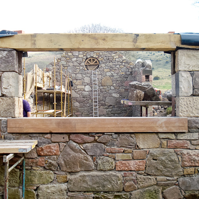 Looking towards the gable end of a traditional stone masonry new build